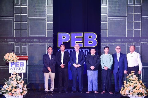  PEB Steel's board of directors take a picture with the delegates
